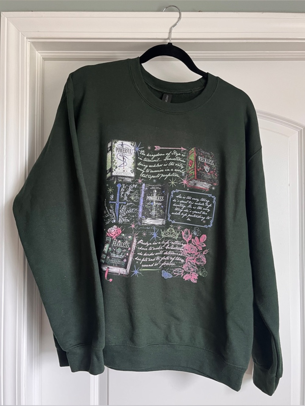 Forest green Gildan crewbeck sweatshirt featuring the books of Lauren Robert’s